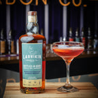 Bottle of Larrikin Bottled-In-Bond Under U.S. Govt. Supervision Kentucky Straight Bourbon Whiskey 750ml with a cocktail glass